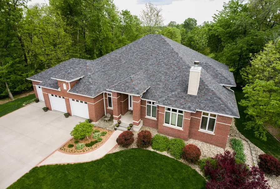 Aerial view of a home roofed with Malarkey Legacy Class 4 impact-resistant shingles in Black Oak