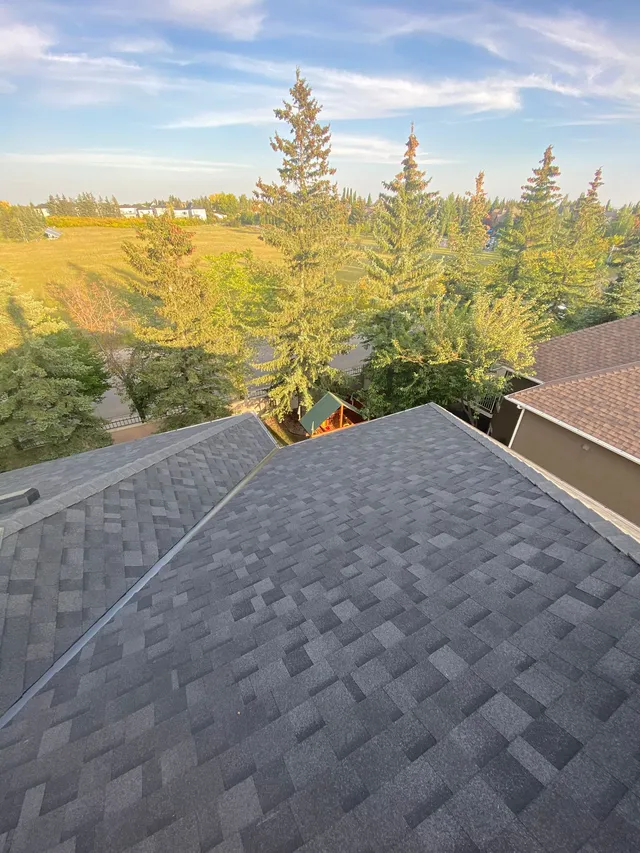 New metal valley span on the rear facet of a Calgary house roof after repair