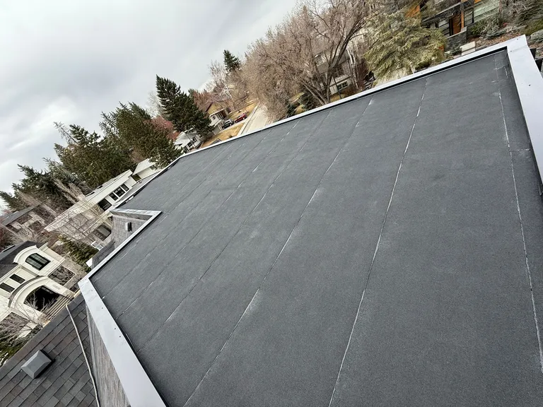 Residential flat roof membrane installed in combination with asphalt shingles in Calgary