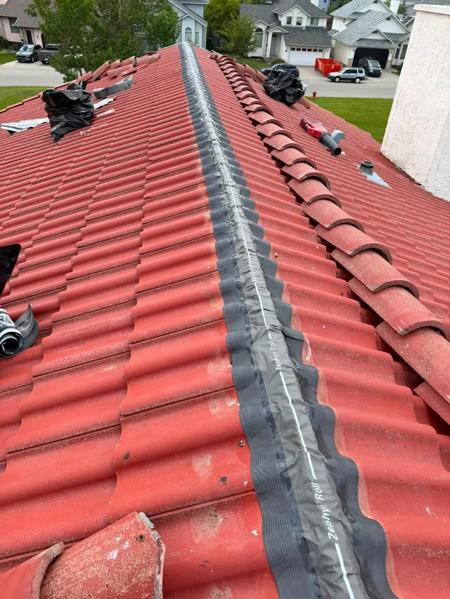 Zephyr Roll dry-ridge vent by Westlake Royal Building Products rolled out along a concrete tile roof ridge